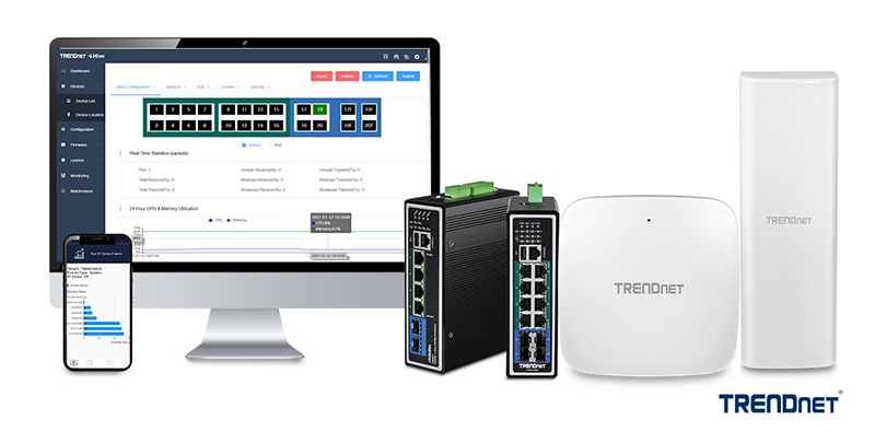 The illustration depicts a computer monitor showing a network management interface with various configuration options and real-time statistics. Below the monitor, a smartphone displays a graph related to network performance. In front of the monitor and smartphone, two industrial network switches, a wireless access point, and a long-range wireless antenna are branded with the TRENDnet logo. The interface on the monitor includes sections for basic configuration, network, PoE, system, and security, along with real-time statistics for packet transmission and reception, and a 24-hour CPU and memory utilization graph