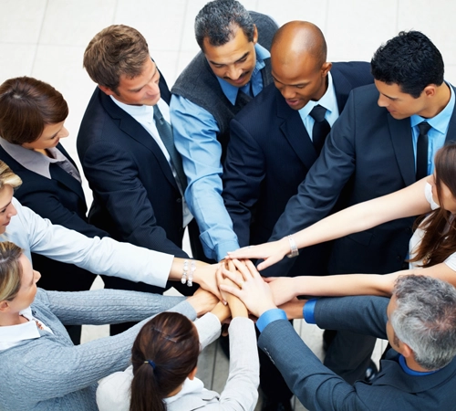 A group of people putting their hands together